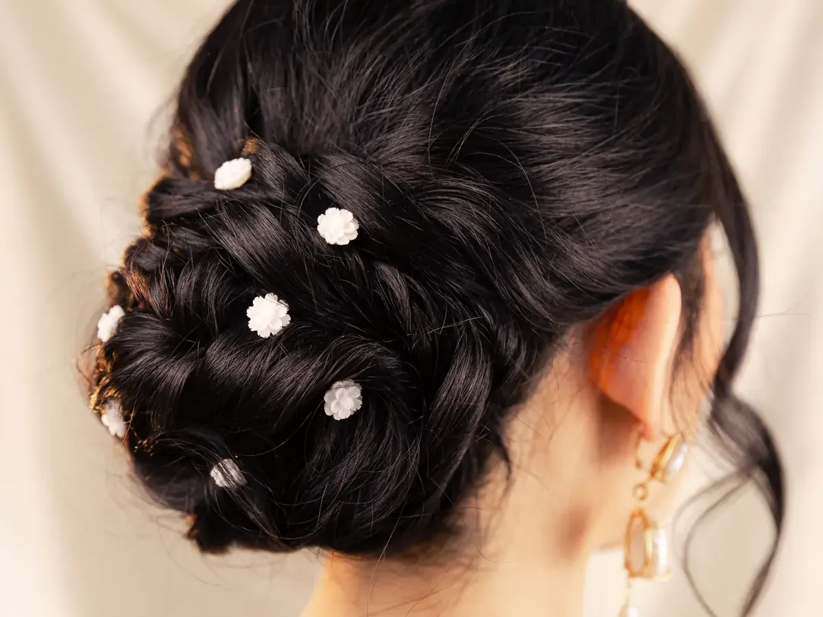 Updo with small white flowers, seen from behind